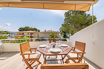 A table with plates and a bottle of wine on it