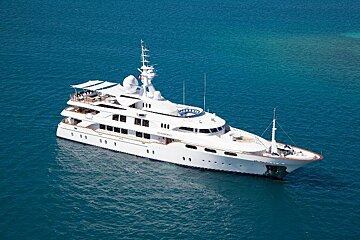 A large white yacht is floating in the ocean