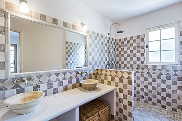 A bathroom with two sinks and a large mirror