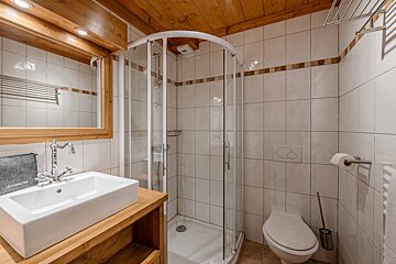 A bedroom in a wooden cabin with a large bed