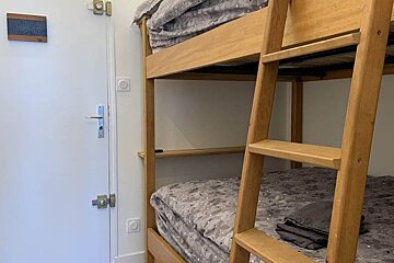 A bunk bed with a ladder leading up to it