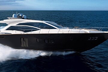 A black and white yacht is floating in the ocean
