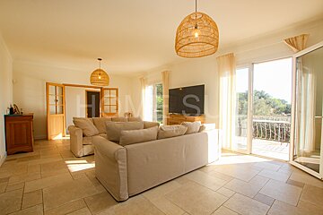 A living room with a couch and a television and the word homes on the wall