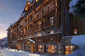 A grand, rustic alpine chalet made of wood and stone, snow-covered and warmly lit at dusk, with people strolling on a snowy path.