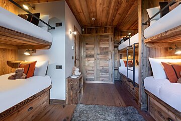 Bunk beds in a room with a wooden ceiling