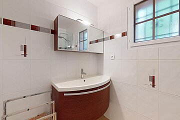 A bathroom with a sink a mirror and a window