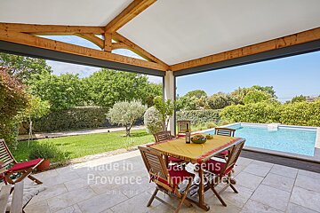 A patio with a table and chairs and a sign that says made in provence