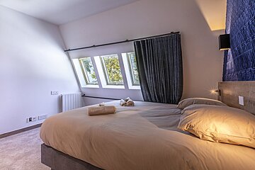 A bedroom with a bed and two towels on it