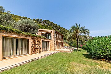 A house with a large lawn in front of it