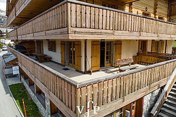 A wooden balcony with the letter v on it