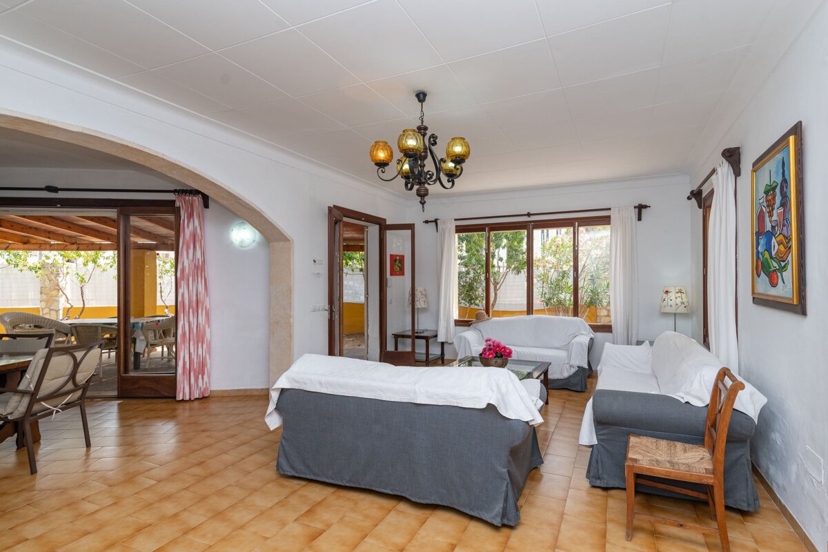 A living room with two couches and a chandelier