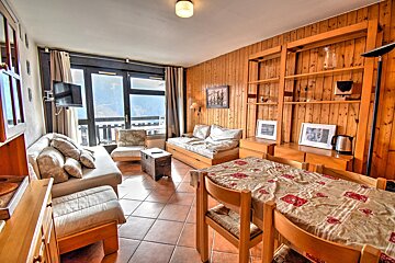 A living room with a table and chairs and a couch