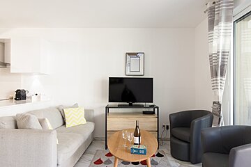 A bottle of wine sits on a table in a living room