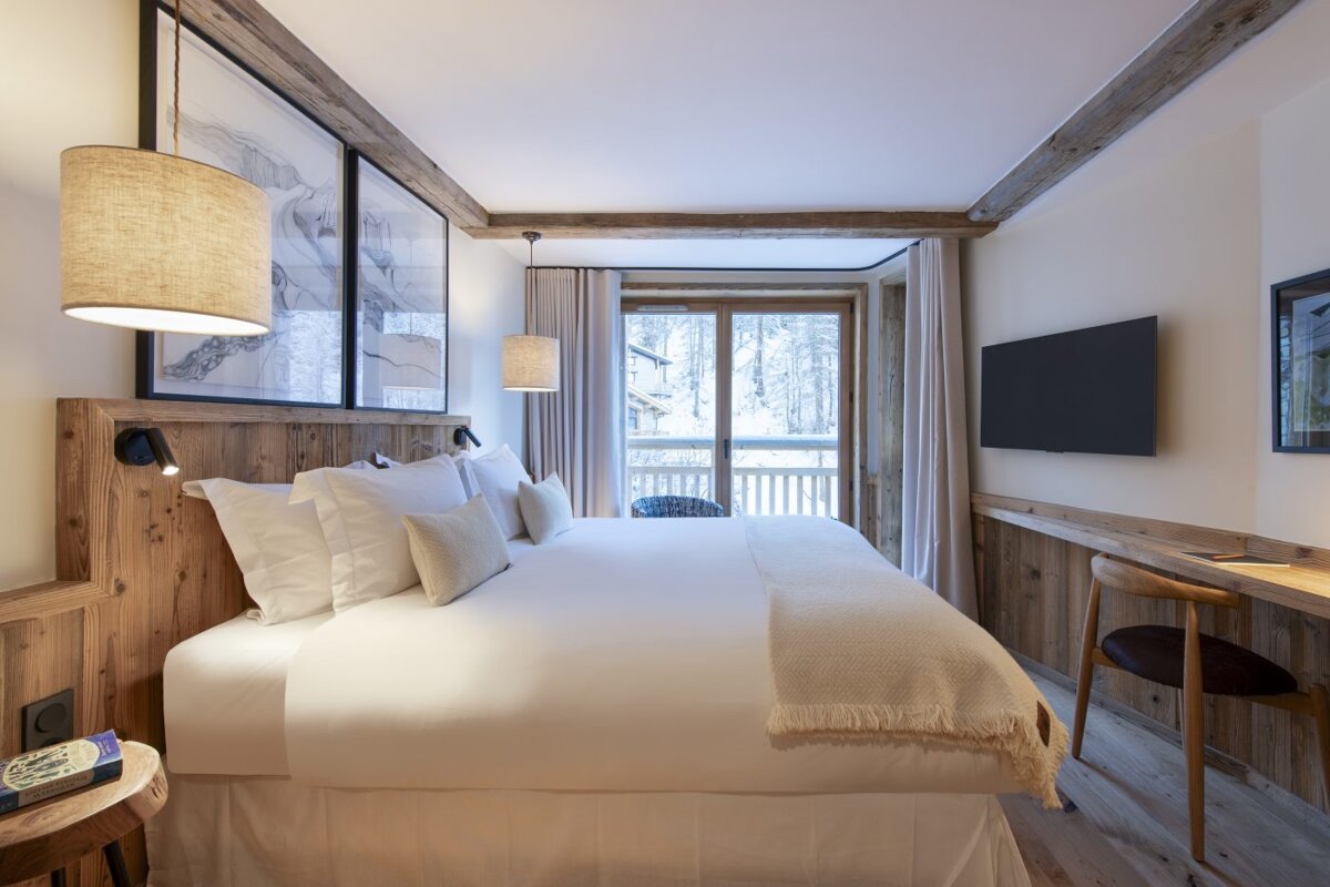 A hotel room with a large bed and a flat screen tv