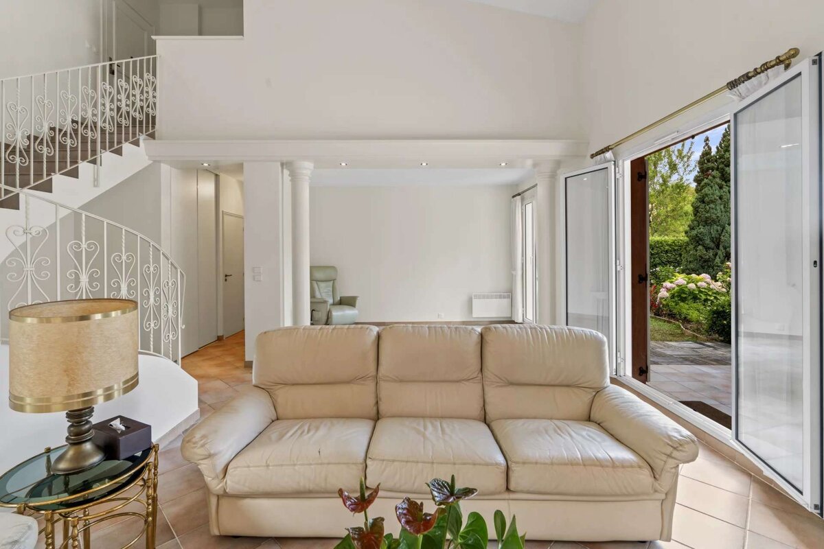 A living room with a couch and a lamp
