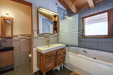 A bathroom with a bathtub and a sink