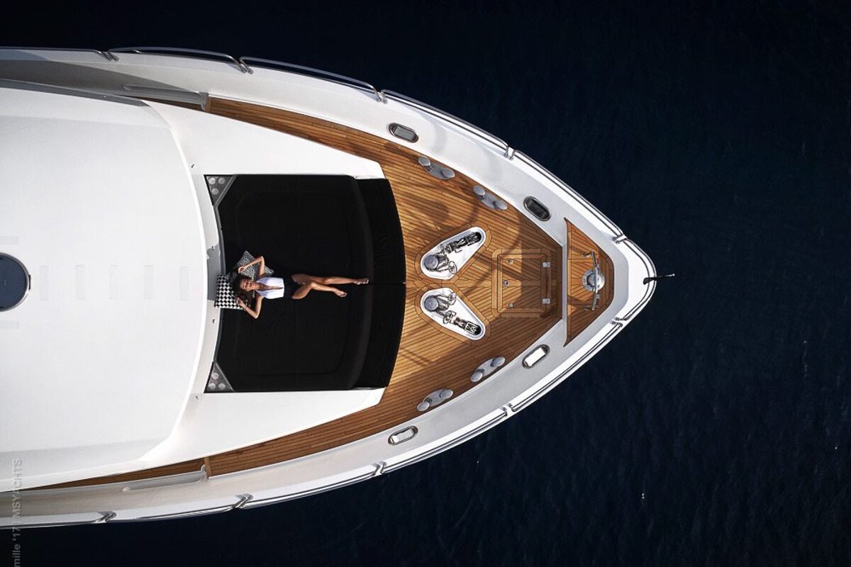 An aerial view of a woman laying on the deck of a boat