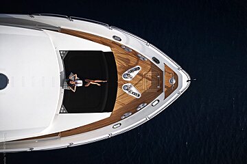 An aerial view of a woman laying on the deck of a boat