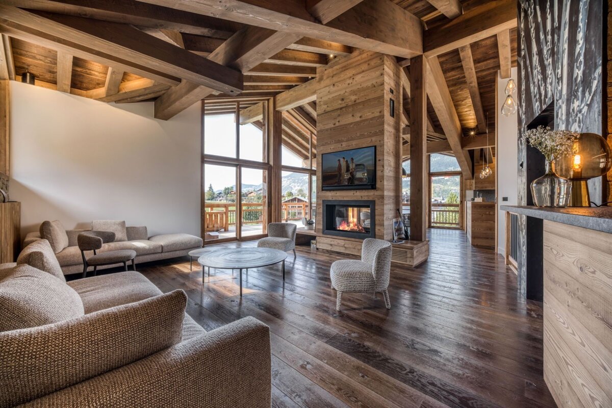 A living room with a couch and chairs and a fireplace