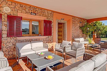 A patio with a couch and chairs and a table