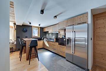 A kitchen with stainless steel appliances and wooden cabinets