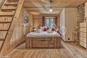 A bedroom with a wooden bed and a sign that says ten80 holidays
