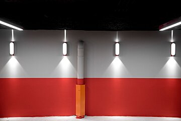 A red and white wall with lights on it