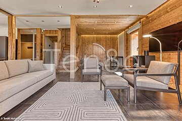 A living room with a couch and chairs and a sign that says ten80 holidays