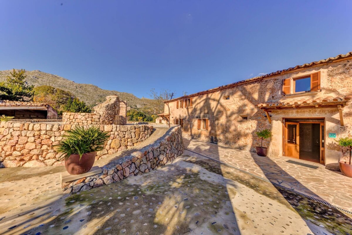A stone building with a green sign on the door