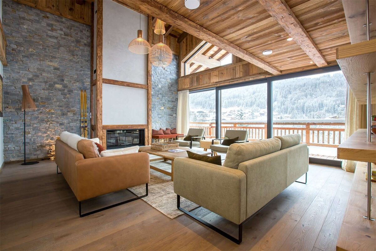 A living room with a couch and chairs and a fireplace