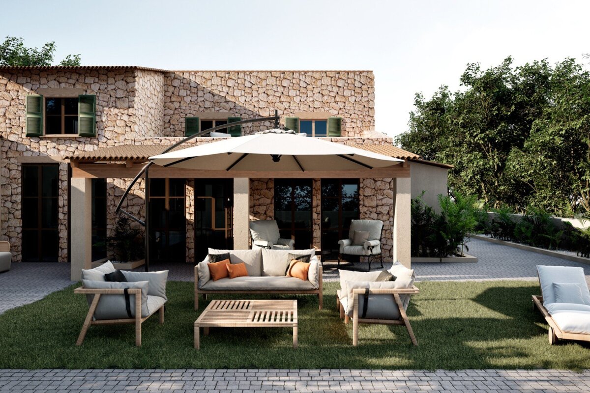 A patio with a couch and chairs under an umbrella