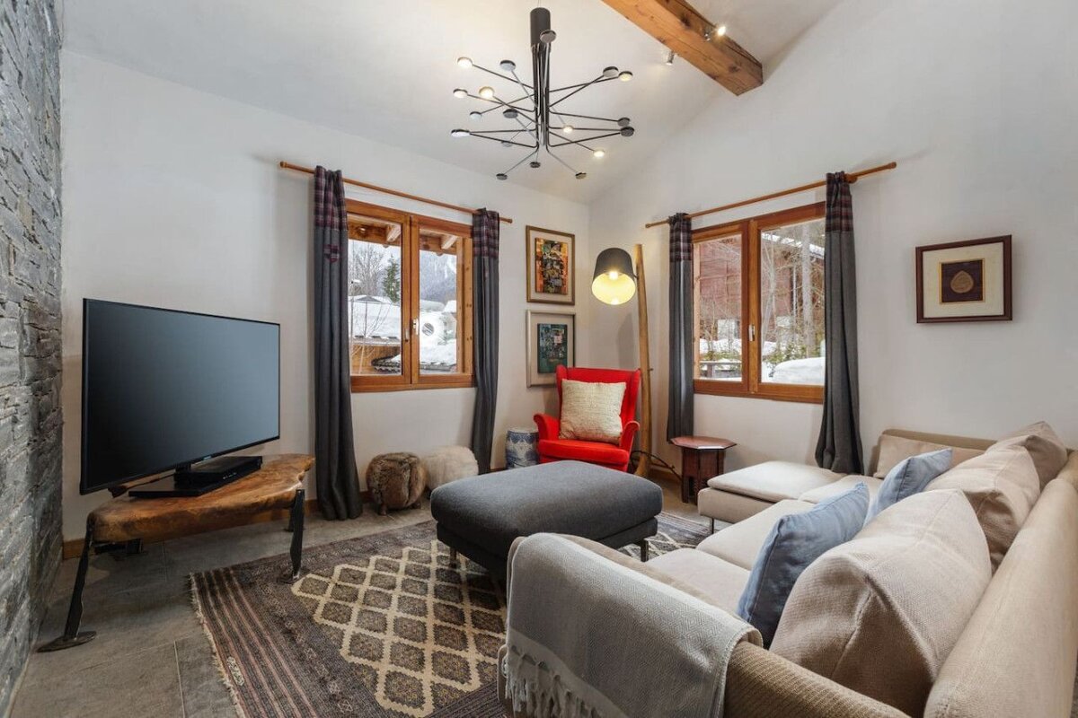 A living room with a couch a chair and a flat screen tv