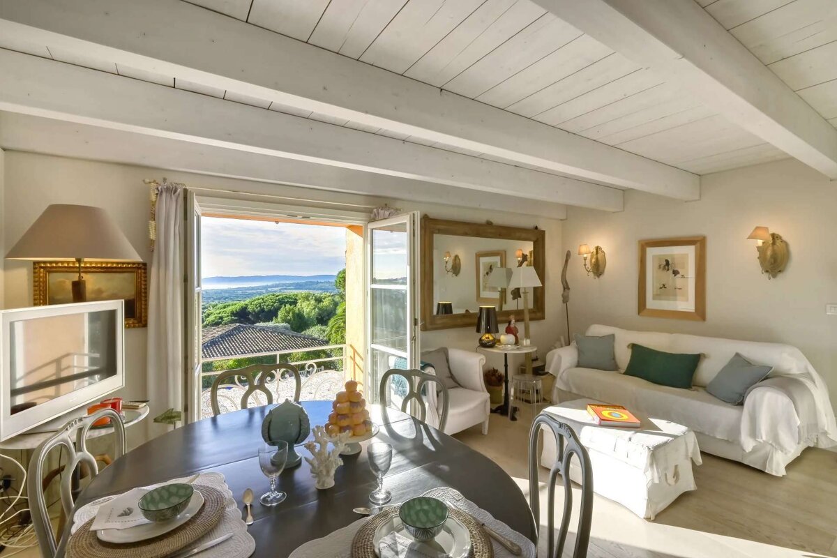 A living room with a dining table and a couch