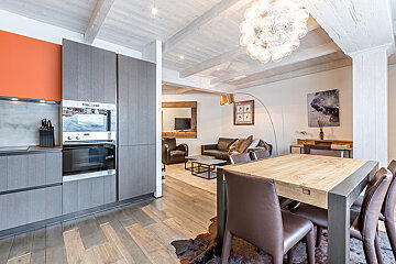 A kitchen and dining area with a table and chairs