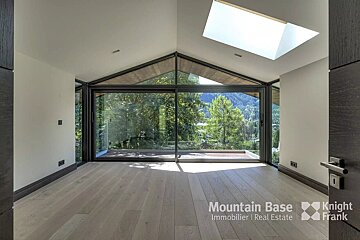 A room with a skylight and a sign that says mountain base