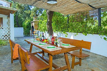 A table with a bottle of red wine on it