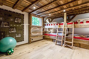 A room with bunk beds and a soccer ball with the word holidays on it