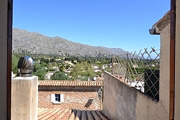A view of a rooftop with mountains in the background