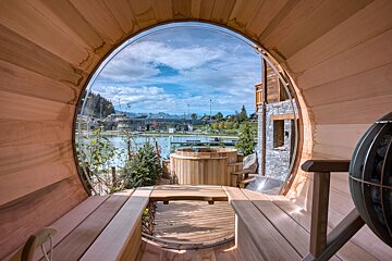 A view of a lake from inside a wooden barrel