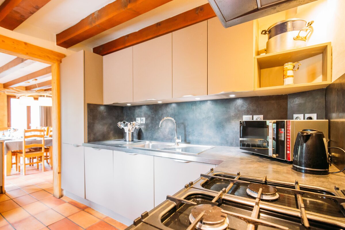 A kitchen with a stove top oven and a microwave