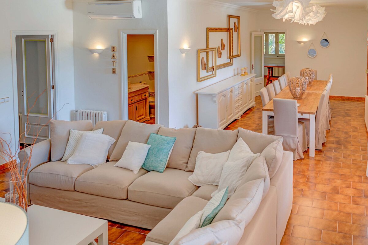 A living room with a couch and a dining table