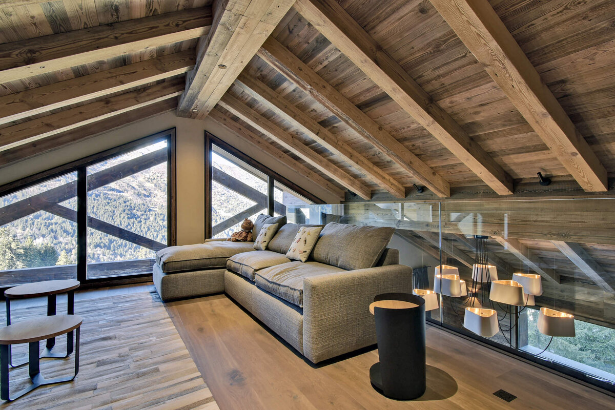 A living room with a couch and a view of the mountains