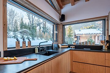 A kitchen with a large window and a sink