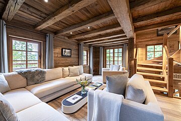 A living room with a staircase leading up to the second floor