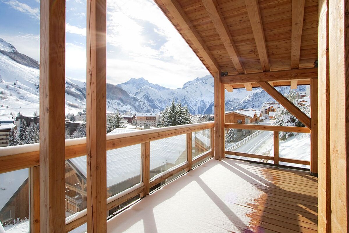 A balcony with a view of snow covered mountains