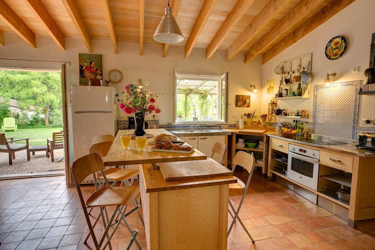 A kitchen with a table and chairs and a refrigerator