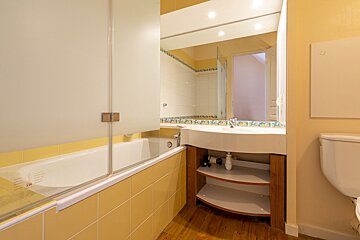 A bathroom with a bathtub and a sink