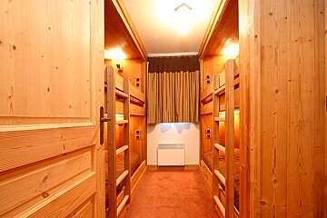 A narrow hallway with bunk beds in it