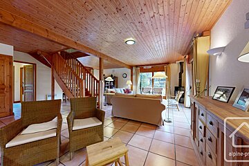 A living room with a couch and chairs and a sign that says alpine-pro