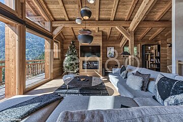 A living room with a couch and a christmas tree in it